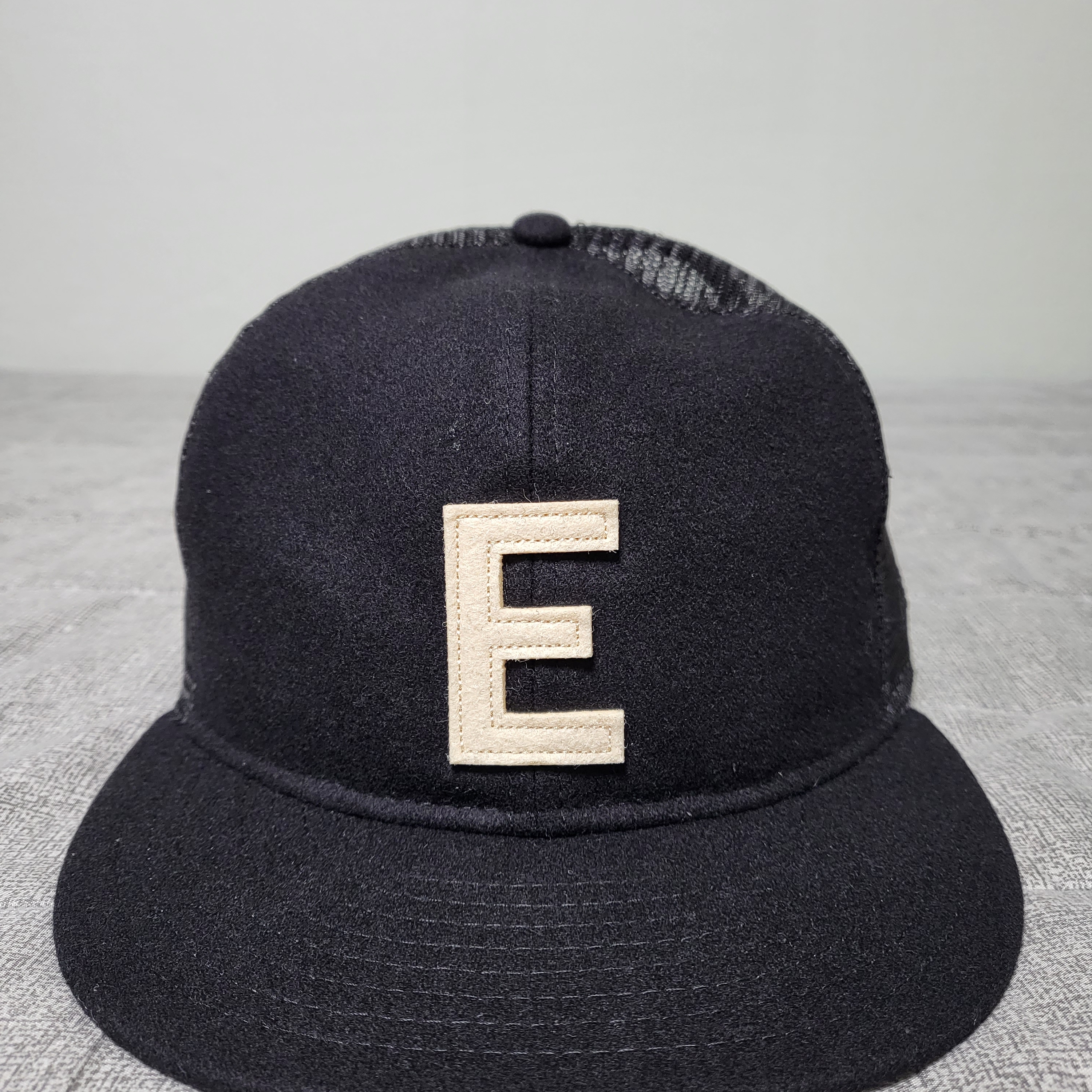 Essentials x New Era E Trucker Cap Black 착용 스타일
