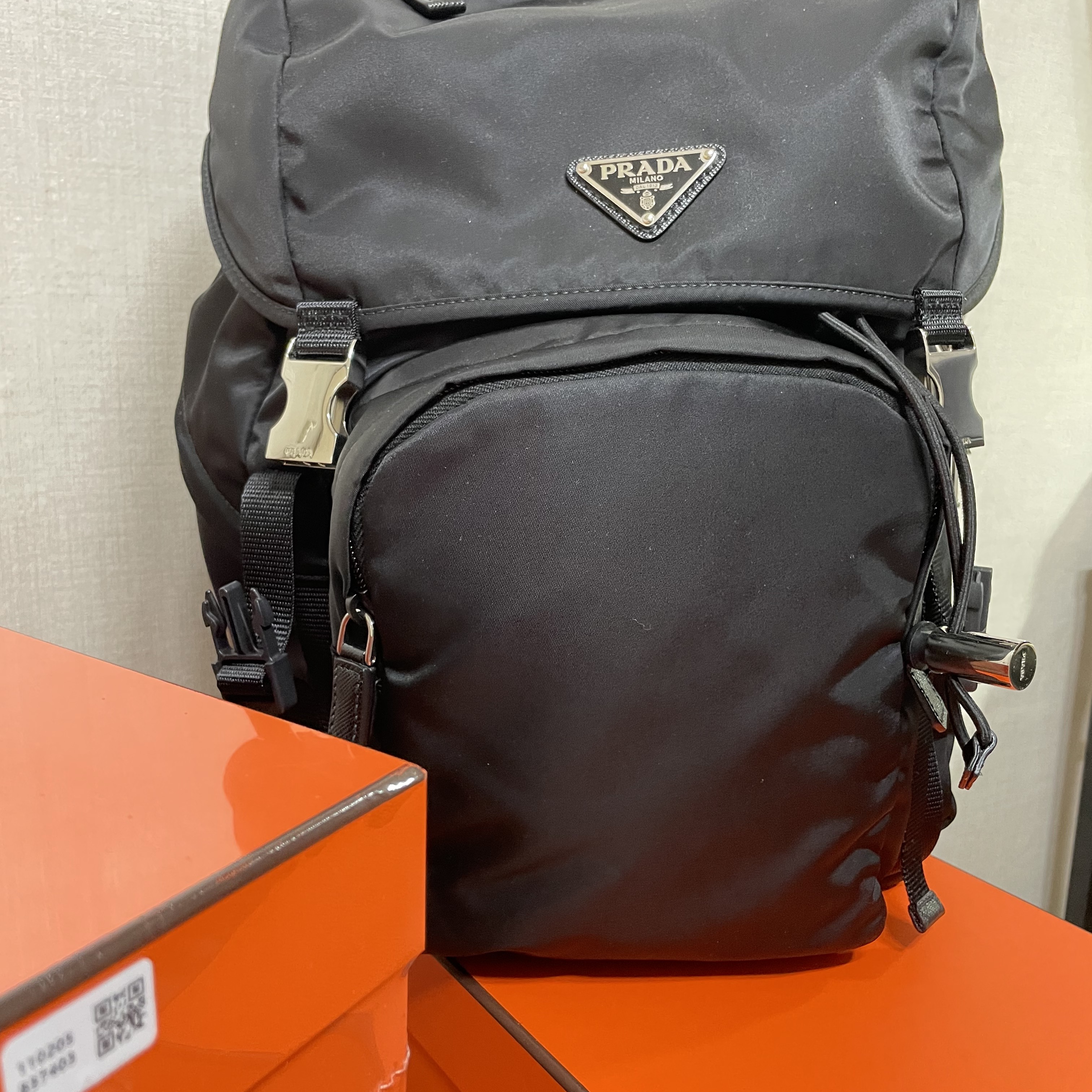 Prada Saffiano Leather Triangle Logo Keychain Black Silver, Prada Re-Nylon and Saffiano Leather Backpack Black 착용 스타일 - 2
