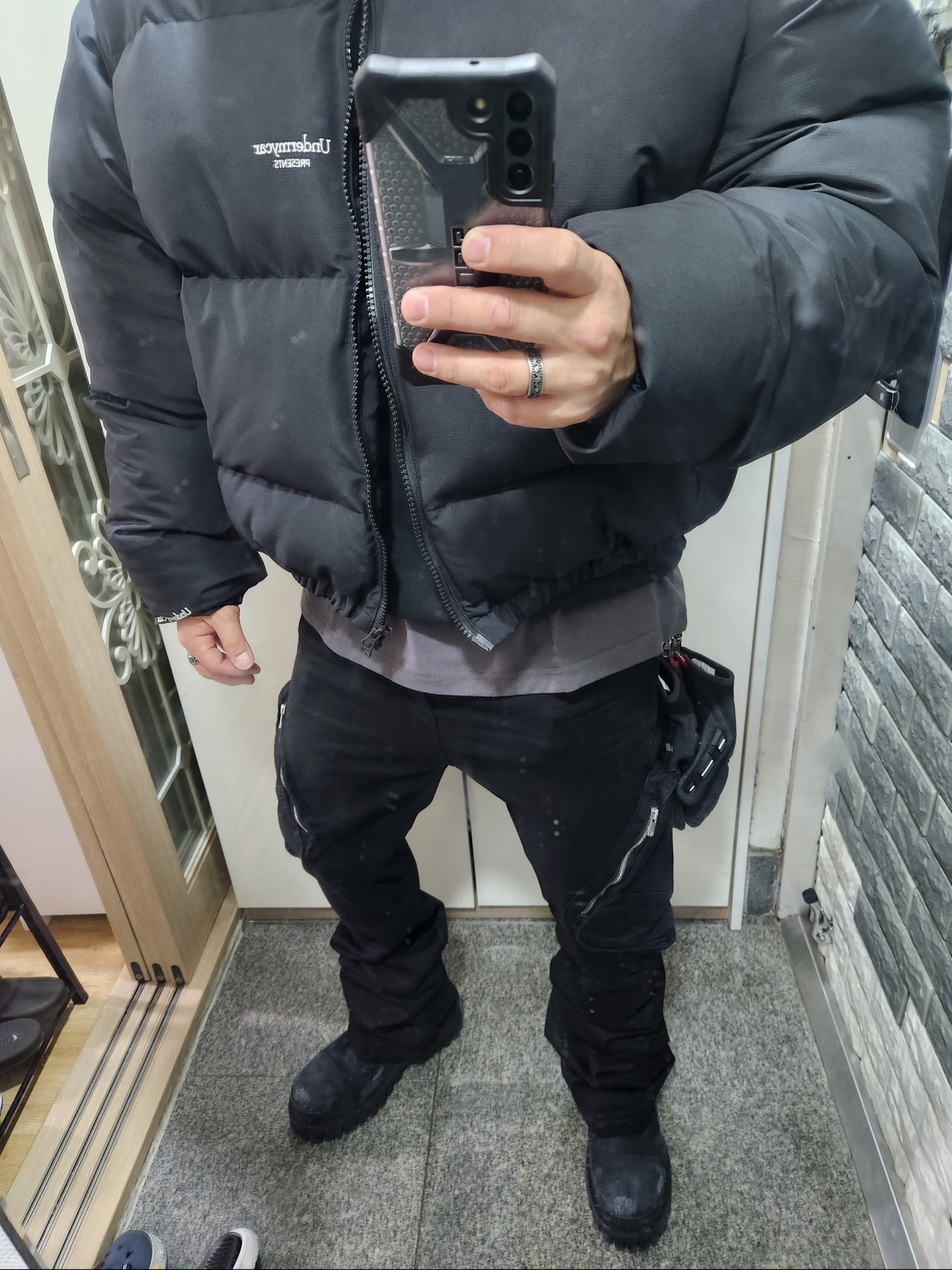 Undermycar Mu.15 Anti Fxxking Logo Play Triple Logo Crop Padding Jacket Black, Undermycar Zerob Embossed Tactic Flared Jeans Sharkskin - 23FW 착용 스타일 - 1