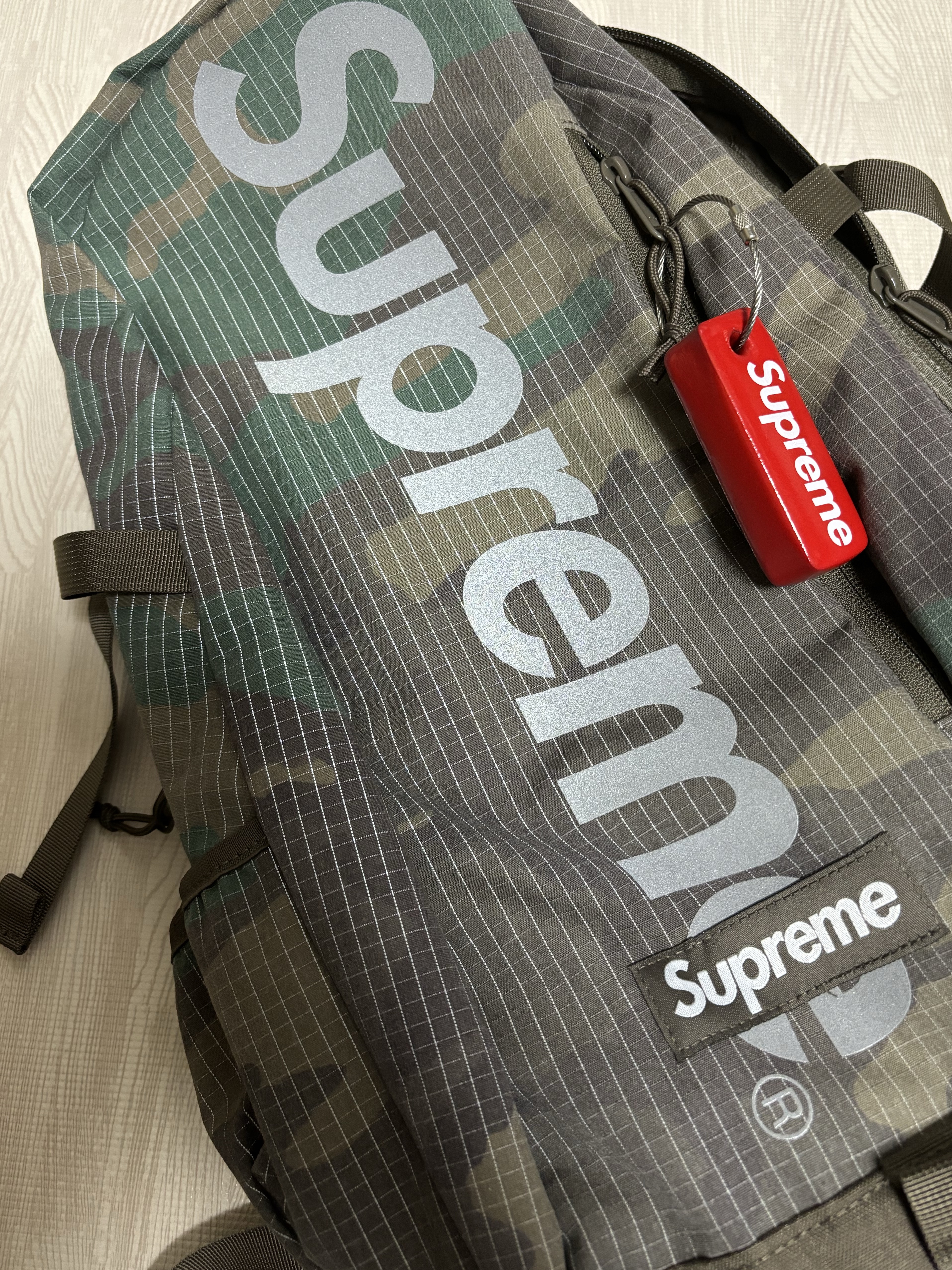 Supreme Backpack Woodland Camo - 24SS, Supreme Floating Keychain Red - 23FW 착용 스타일