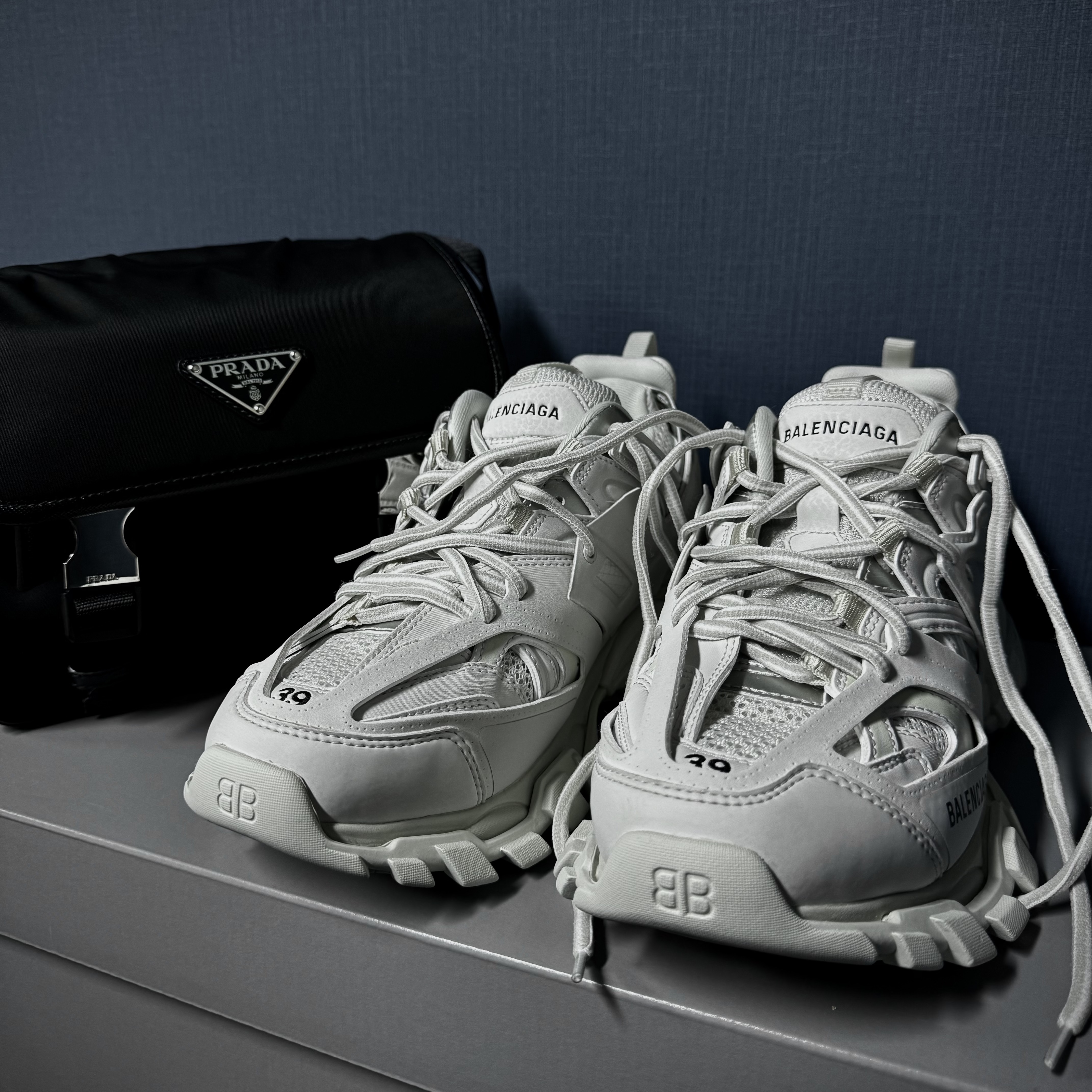Prada Re-Nylon and Saffiano Leather Shoulder Bag Black, (W) Balenciaga Track Sneakers Recycled Sole White 착용 스타일