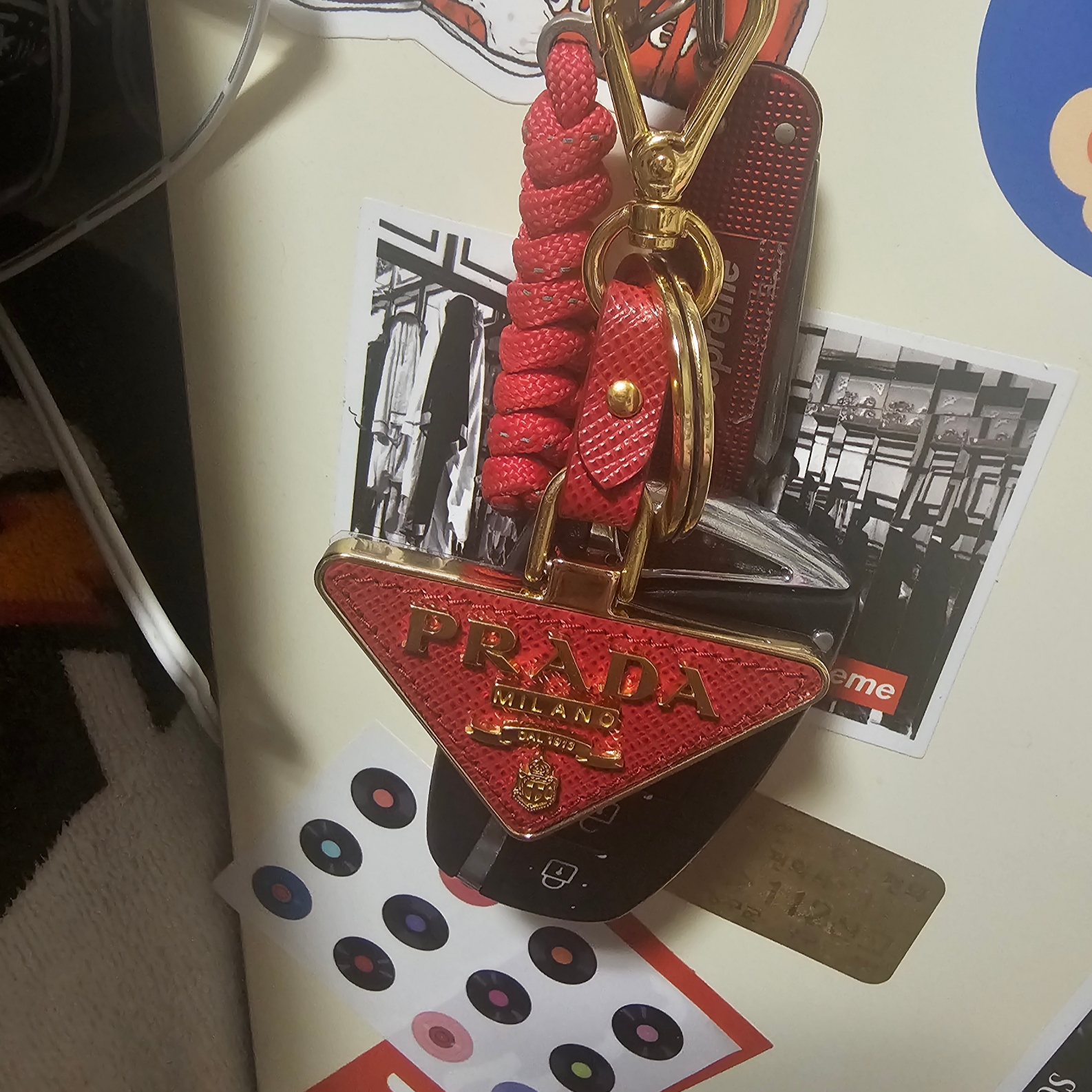 Prada Saffiano Leather Triangle Logo Keychain Fiery Red Gold 착용 스타일