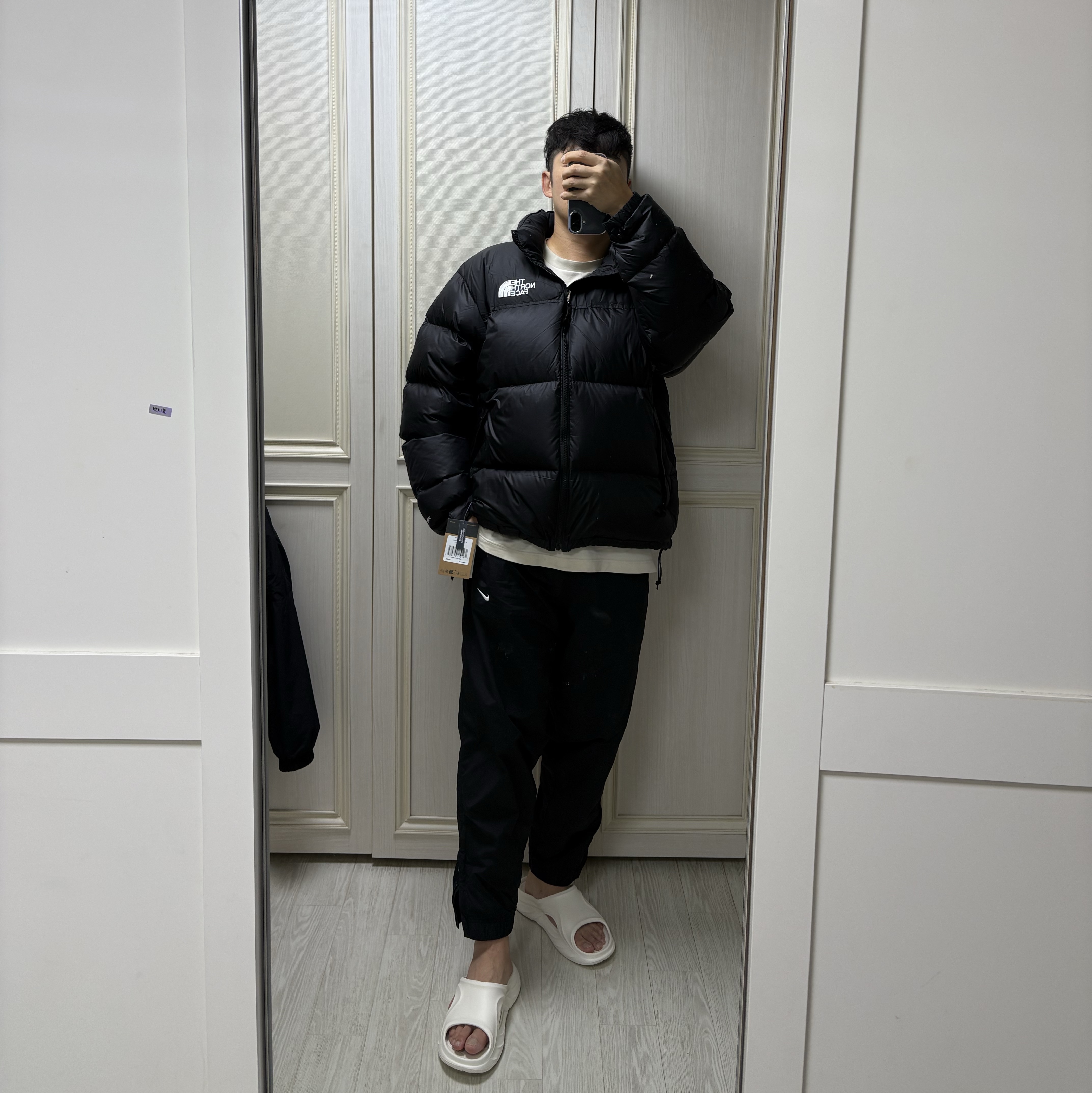 The North Face 1996 Retro Nuptse Down Jacket TNF Black, Nike NRG Solo Swoosh Woven Track Pants Black White - Asia 착용 스타일 - 1
