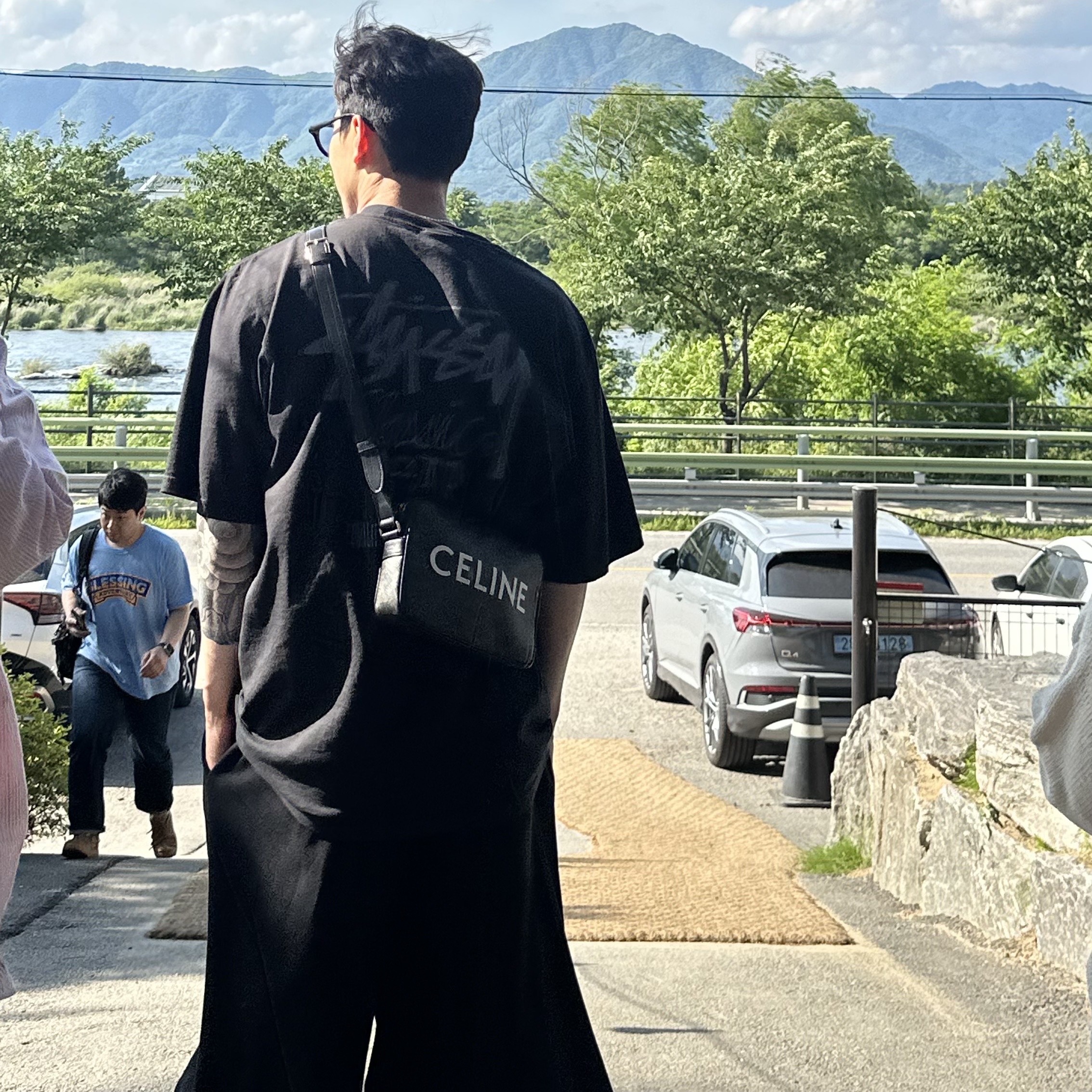 Celine Medium Messenger Bag in Triomphe Canvas with Celine Print Black, Stussy Pigment Dyed Classic Gear T-Shirt Black 착용 스타일