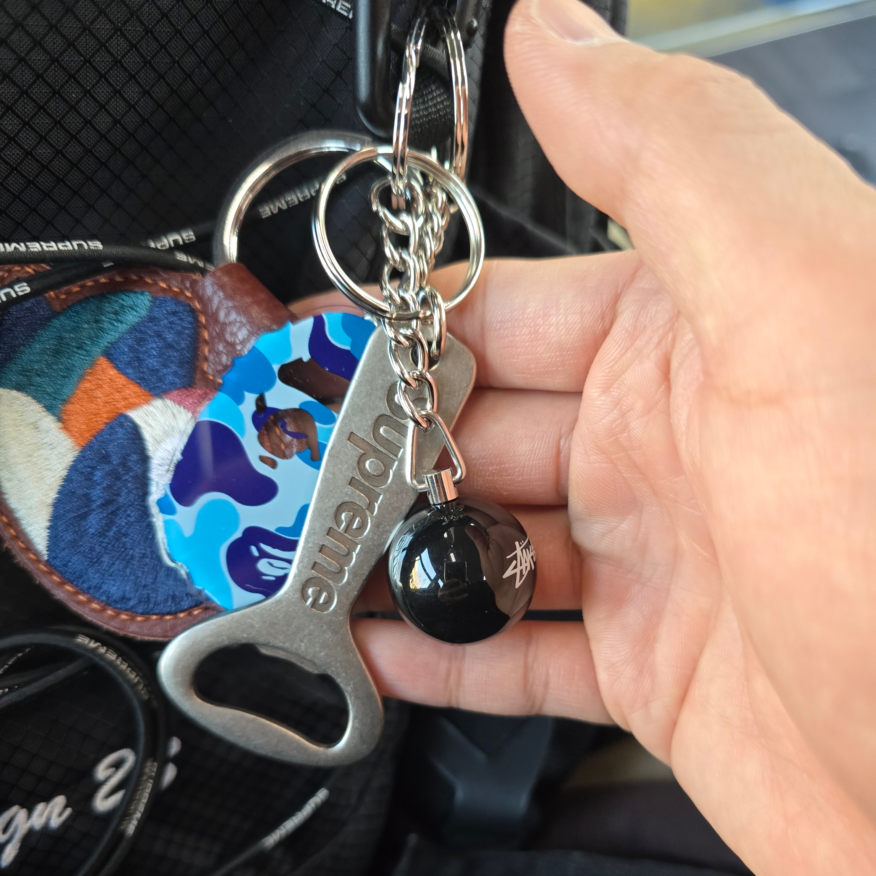 BAPE ABC Camo Ape Head Acrylic Keychain Blue, Supreme Bottle Opener Keychain Silver - 24FW 착용 스타일