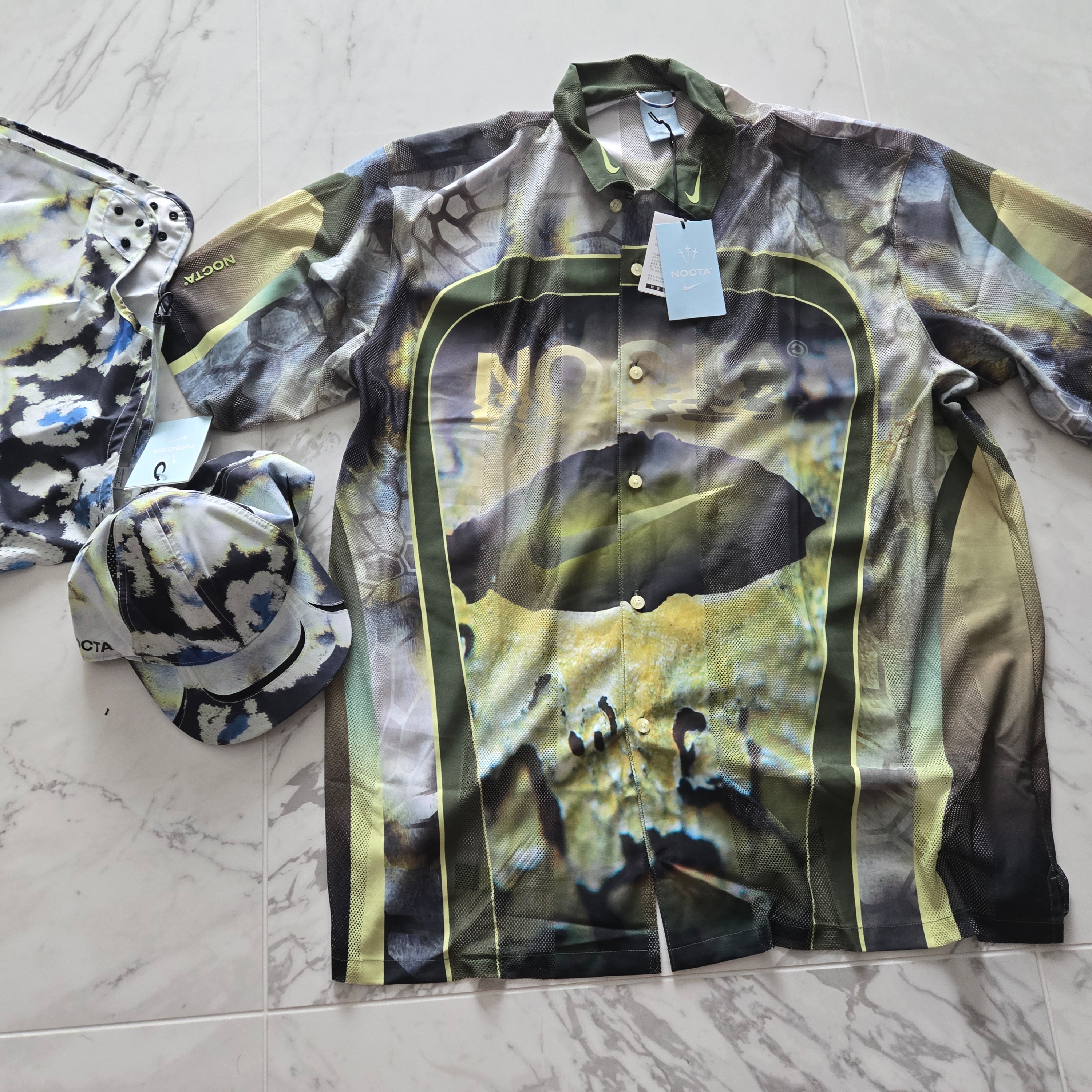 Nike x Drake Nocta Opal Tito Neeks Button Down Short Sleeve Top Pilgrim (FV1939-378), Nike x Drake Nocta Opal SSC Deep Cover Hat Off White 착용 스타일