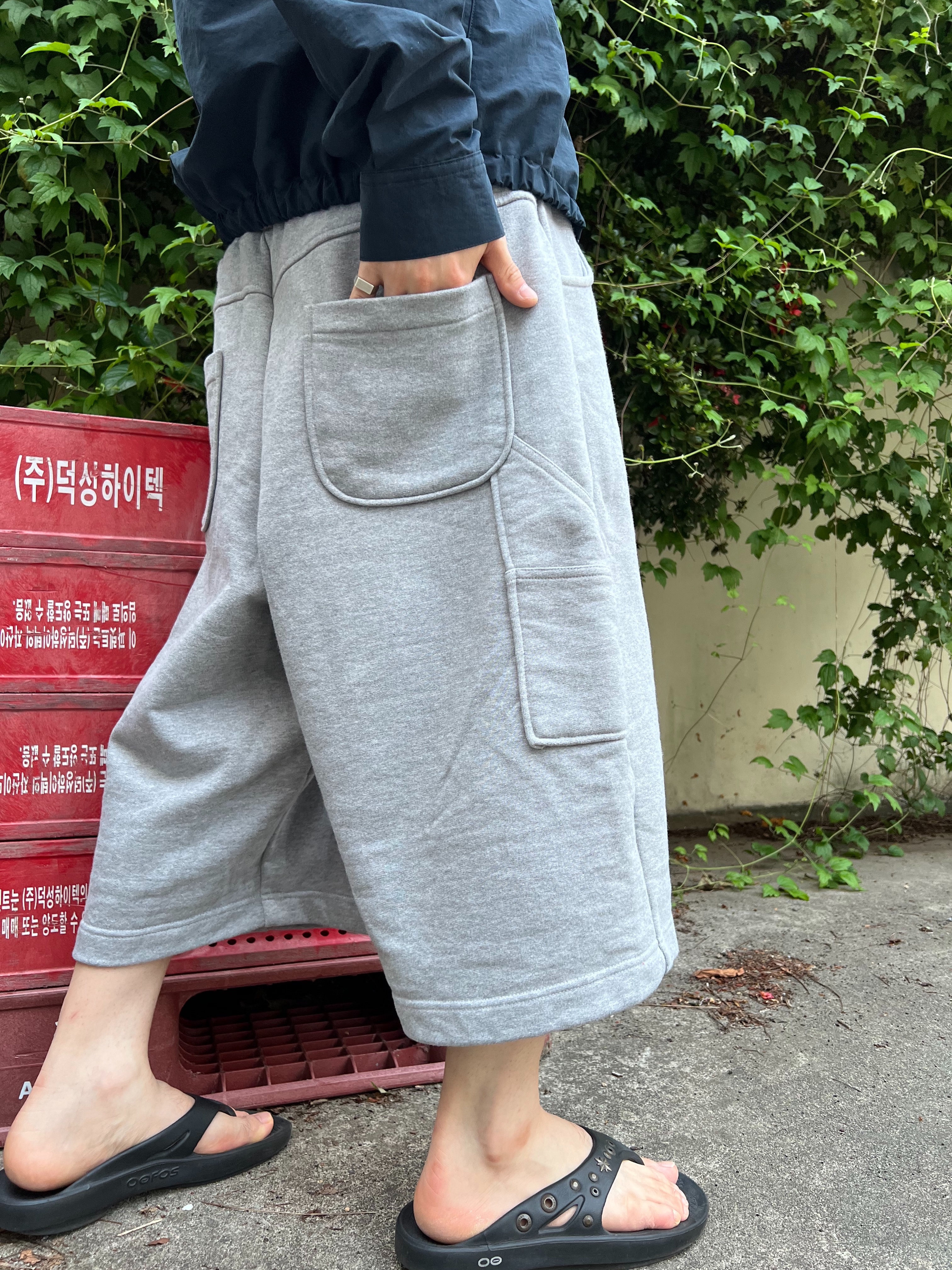 Oofos x Andersson Bell OOriginal Flip Flop Black, MJD Wide Carpenter Bermuda Shorts Melange Grey 착용 스타일 - 2