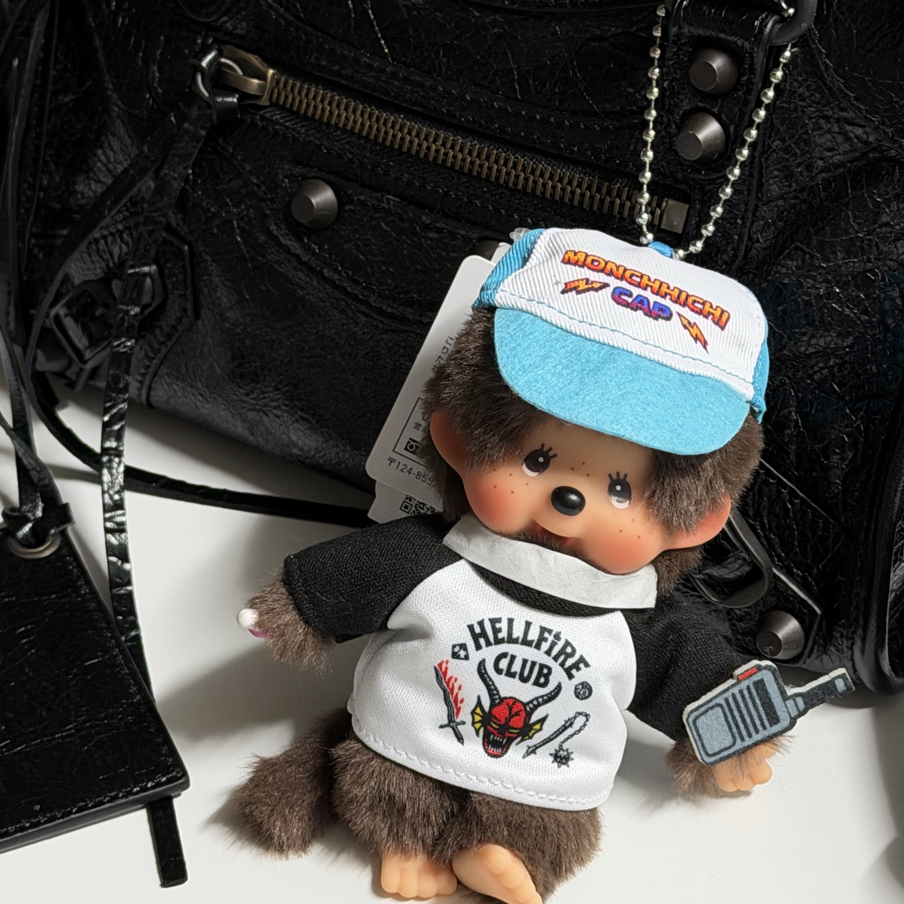 Monchhichi x Strange Things Key Chain Hellfire Club, Balenciaga Le City Mini Bag Black 착용 스타일